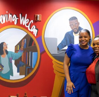 Artist Leah Renee (left) and Aginah Muhammad, assistant vice provost for student success, at the African American Academic Network mural 